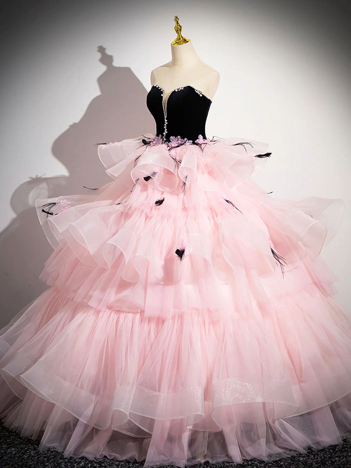 pink dress with black A-Line Off The Shoulder Sparkly Sequin Tiered Prom line pink prom dress has a strapless neckline Pink A-line Strapless Black Top